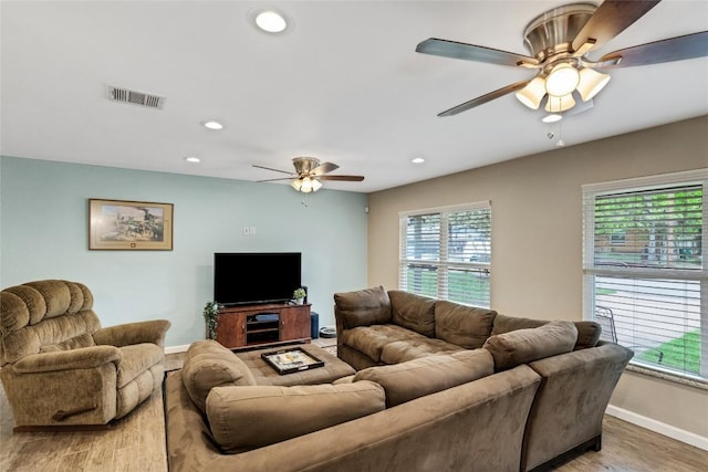 living room featuring ceiling fan and wood-type flooring