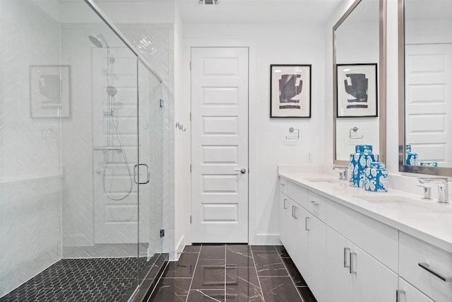 bathroom with vanity and a shower with door