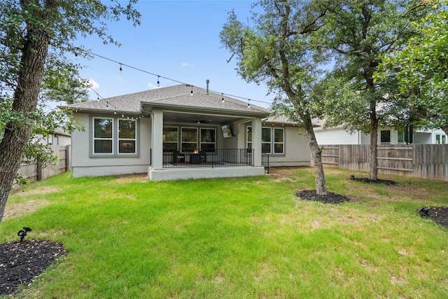 rear view of property with a yard