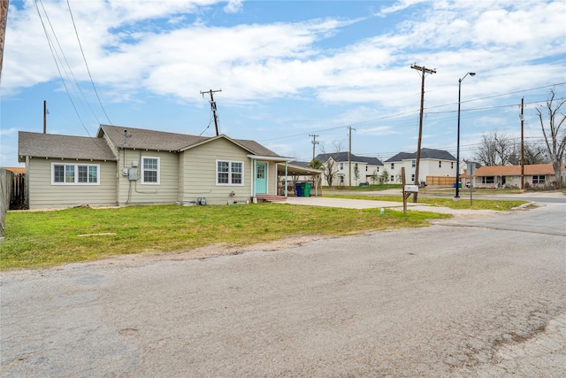 exterior space with a front lawn and a carport