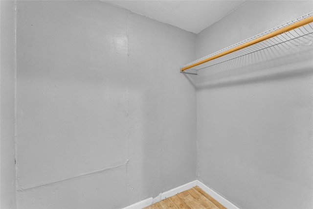 spacious closet featuring hardwood / wood-style flooring