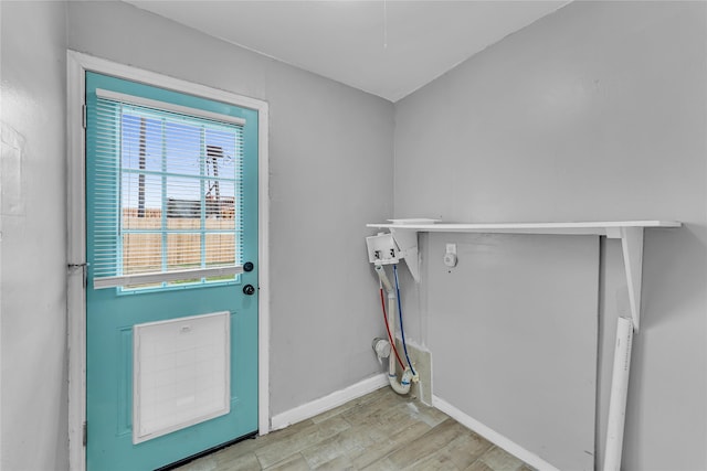 clothes washing area with washer hookup and light hardwood / wood-style flooring