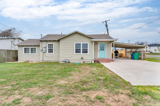 view of front facade with a front yard and a carport