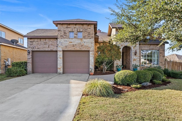 view of front of house featuring a front yard and a garage