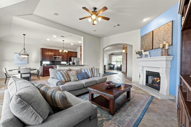 living room featuring ceiling fan and vaulted ceiling