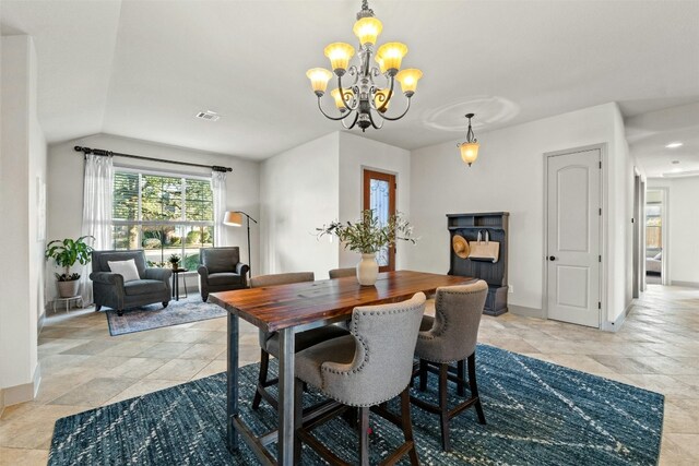 dining room with a chandelier and lofted ceiling