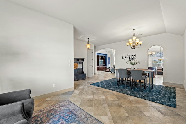 dining room with lofted ceiling and an inviting chandelier