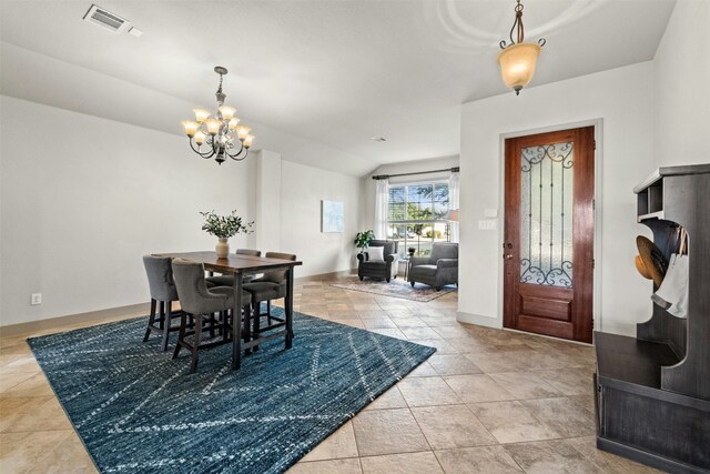 dining space with light tile patterned flooring, lofted ceiling, and a notable chandelier