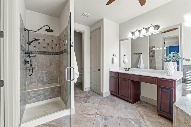 bathroom featuring vanity, ceiling fan, and a shower with door