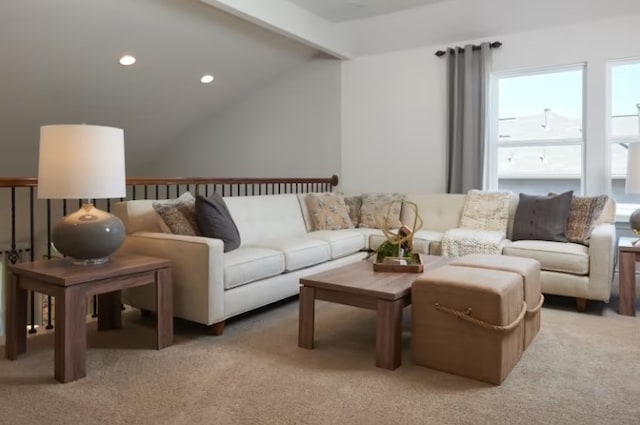 living room featuring lofted ceiling with beams and light colored carpet