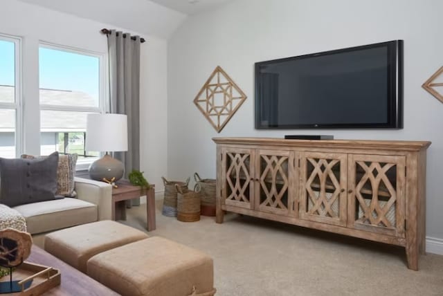 living room with light colored carpet and lofted ceiling