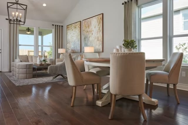 dining space featuring lofted ceiling, dark hardwood / wood-style flooring, and a healthy amount of sunlight