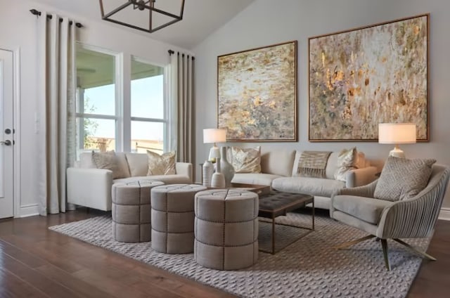 living room featuring a chandelier, dark hardwood / wood-style floors, and vaulted ceiling