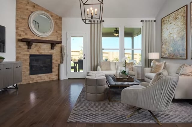 living room with a large fireplace, dark hardwood / wood-style floors, vaulted ceiling, and a notable chandelier