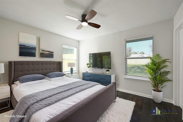 bedroom with ceiling fan and dark hardwood / wood-style floors