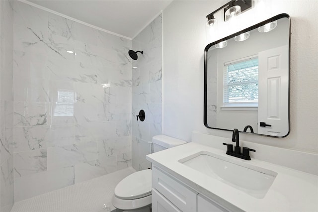 bathroom featuring tiled shower, vanity, ornamental molding, and toilet