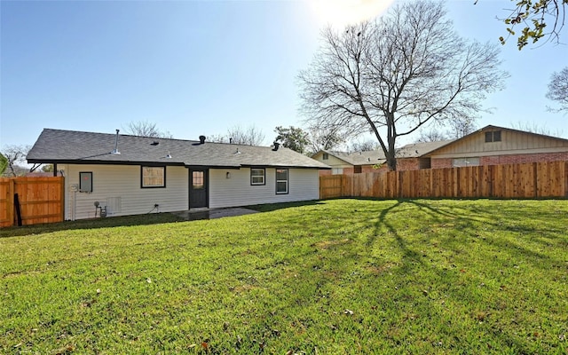 back of house featuring a lawn