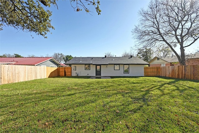 back of house with a yard