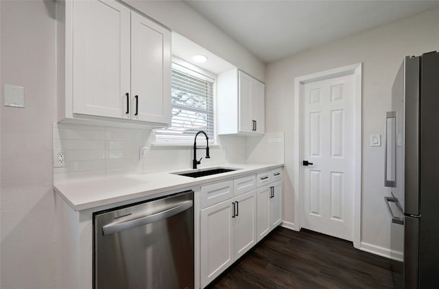 kitchen with sink, stainless steel appliances, dark hardwood / wood-style floors, backsplash, and white cabinets