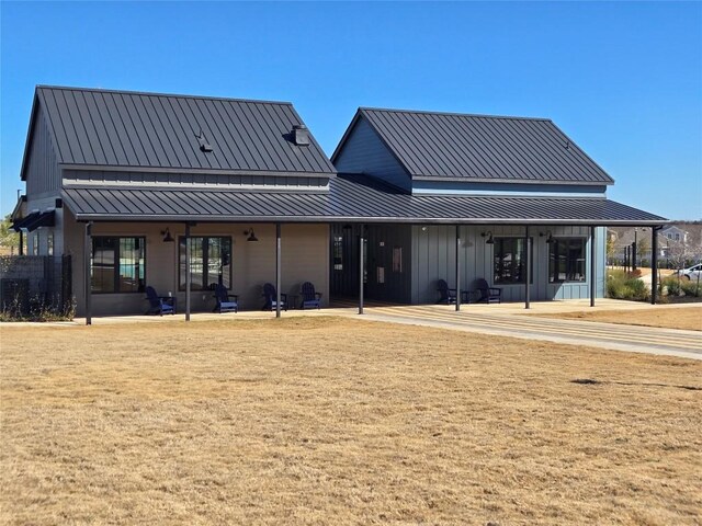 back of house featuring a yard and a patio