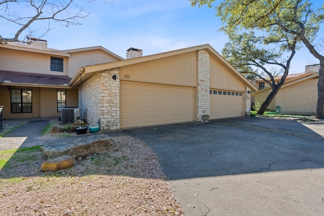 view of front of house with cooling unit and a garage