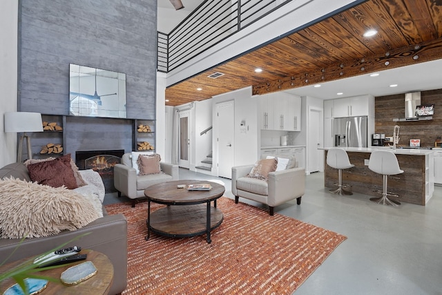 8518 Fathom Cir Unit 133, Austin, TX 78750 - living area with concrete floors, stairway, a fireplace, a high ceiling, and recessed lighting