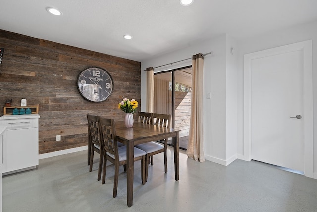 dining area with wooden walls