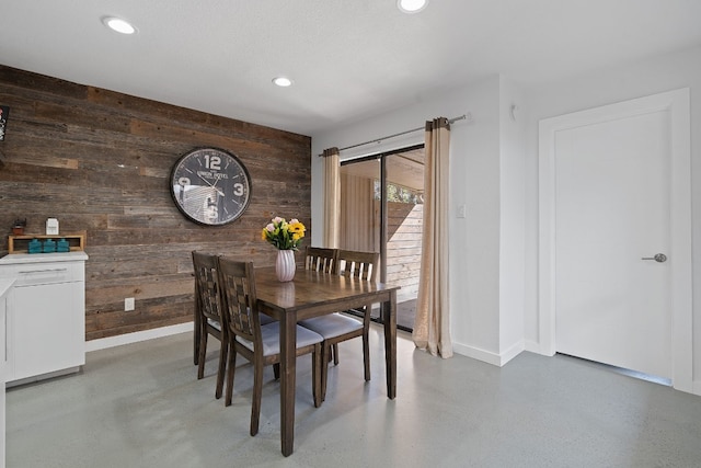 8518 Fathom Cir Unit 133, Austin, TX 78750 - dining area with wooden walls, baseboards, recessed lighting, and concrete floors