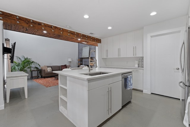 kitchen with a kitchen island with sink, sink, white cabinets, and stainless steel appliances