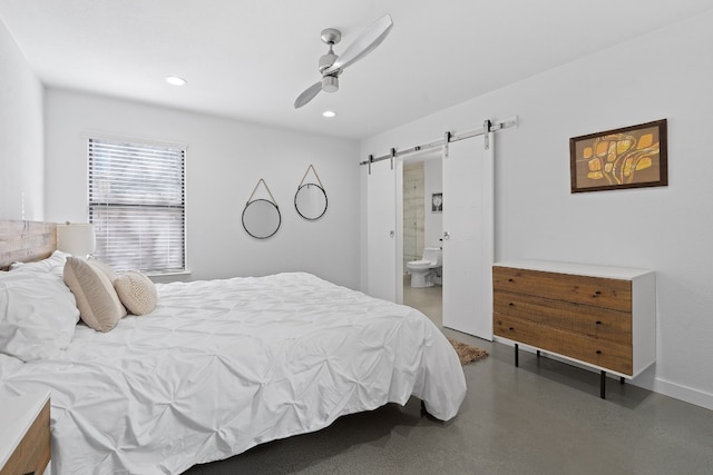 bedroom featuring ceiling fan, a barn door, and ensuite bath