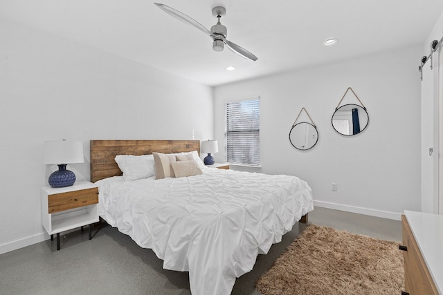 bedroom with a barn door and ceiling fan