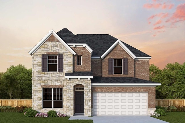 view of front of home featuring a lawn and a garage