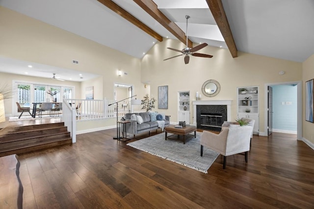 living room featuring beam ceiling, dark hardwood / wood-style flooring, built in features, and ceiling fan