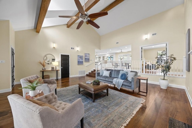 living room featuring beam ceiling, dark hardwood / wood-style floors, high vaulted ceiling, and ceiling fan