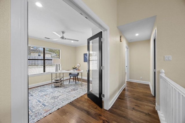 corridor with ornamental molding and dark wood-type flooring