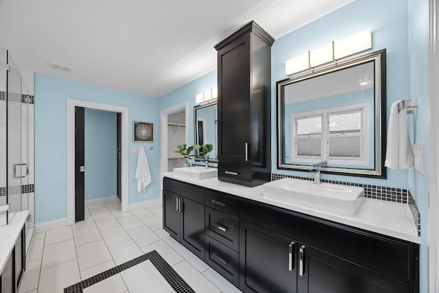 bathroom with tile patterned flooring, vanity, and an enclosed shower