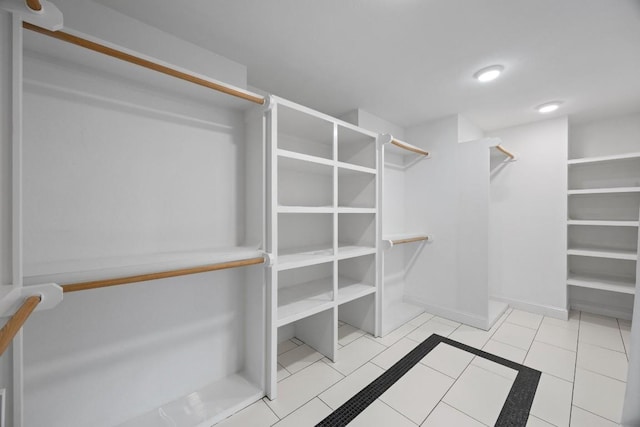 spacious closet with light tile patterned floors