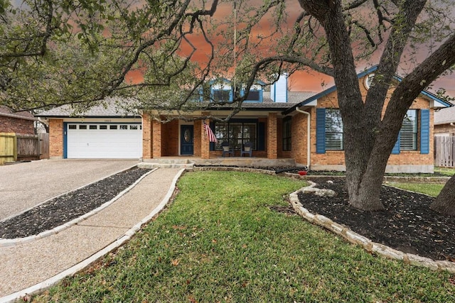 ranch-style house featuring a front yard, a porch, and a garage