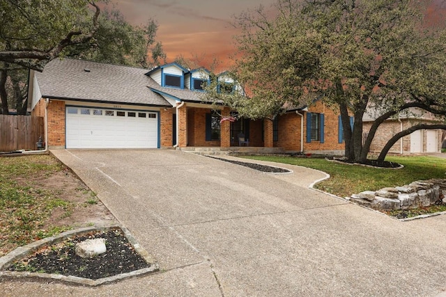 view of front of home featuring a yard and a garage