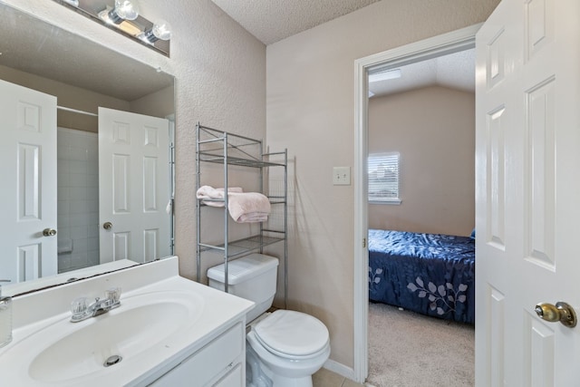 bathroom with vanity, a textured ceiling, toilet, and vaulted ceiling