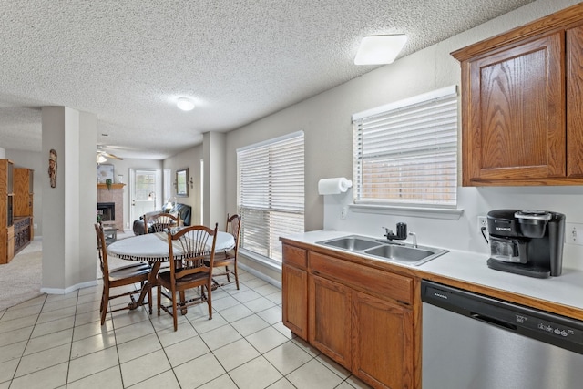 kitchen with dishwasher, ceiling fan, light tile patterned flooring, and sink