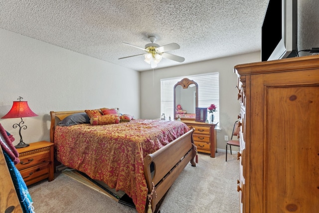 carpeted bedroom with a textured ceiling and ceiling fan