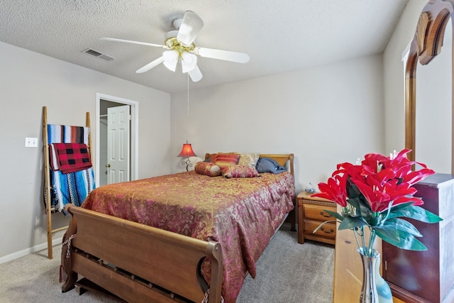 carpeted bedroom featuring a textured ceiling and ceiling fan