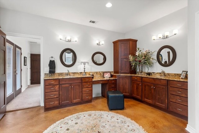 bathroom with tile patterned floors, french doors, and vanity