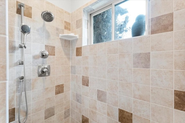 bathroom with tiled shower