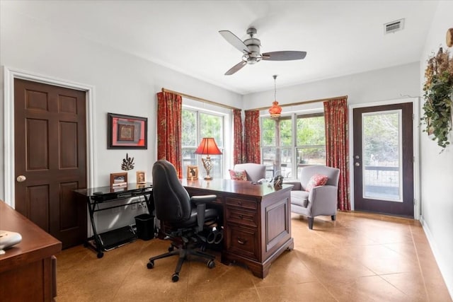 tiled home office featuring ceiling fan