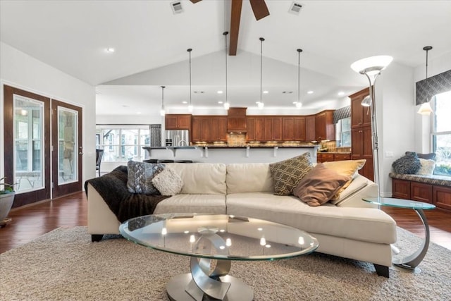 living room featuring vaulted ceiling with beams and dark hardwood / wood-style floors