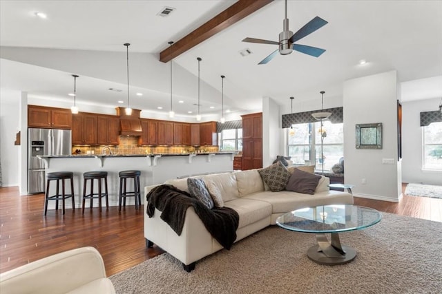 living room with beamed ceiling, ceiling fan, dark hardwood / wood-style flooring, and high vaulted ceiling