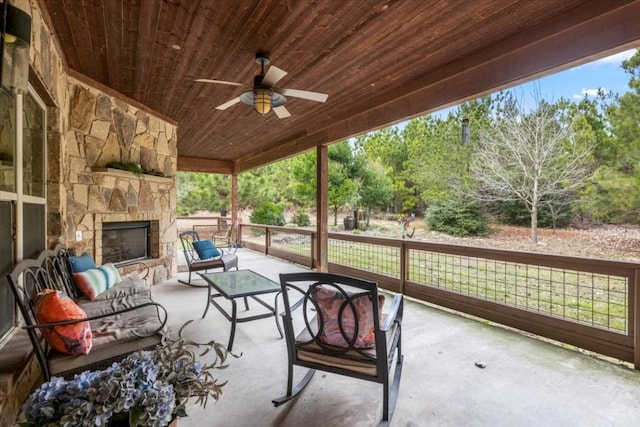 view of patio featuring an outdoor living space with a fireplace and ceiling fan