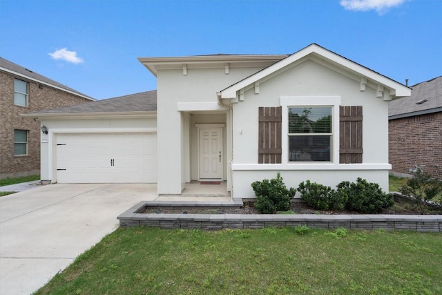 view of front of property with a garage and a front lawn